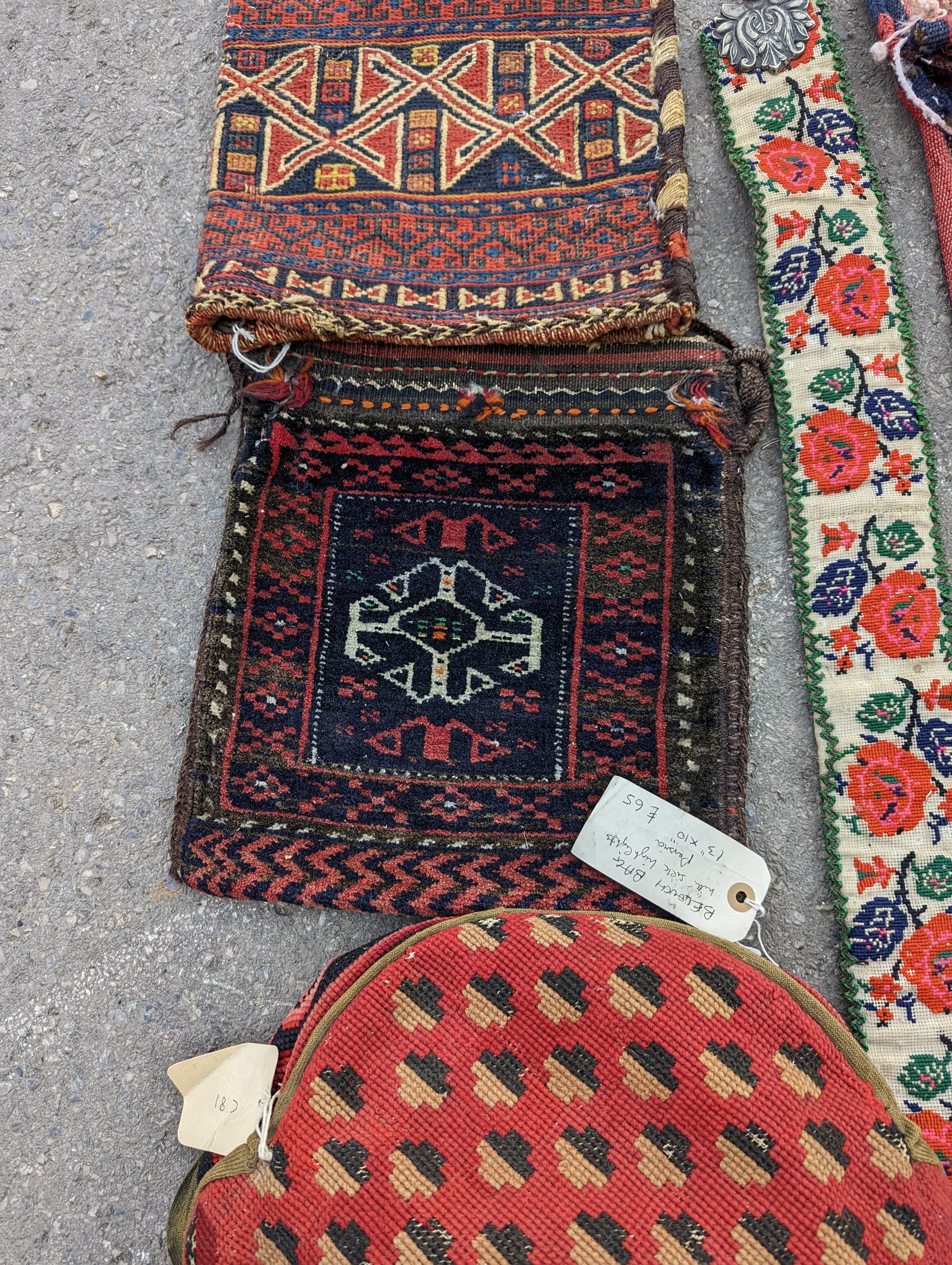 An Afghan Kilim flatweave saddlebag, 144 x 69cm together with six assorted bags, faces, etc.